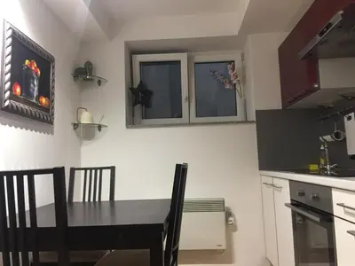 a kitchen with a black table and chairs in a room at Apartment Red Square in Ljubljana