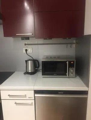 a microwave oven sitting on a counter in a kitchen at Apartment Red Square in Ljubljana