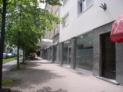 an empty sidewalk in front of a building at Apartment Red Square in Ljubljana