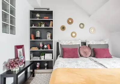 a bedroom with a bed and a book shelf at Blissful Loft Tivoli in Ljubljana