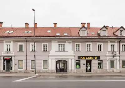 a large white building with a kleine sign on it at Blissful Loft Tivoli in Ljubljana