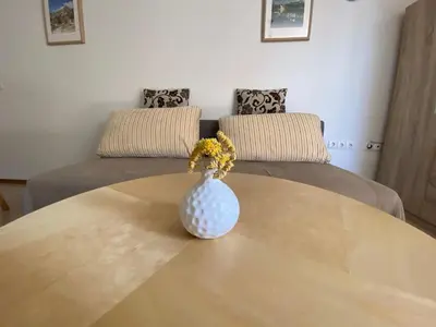 a vase with flowers sitting on top of a table at Apartment Studio Van Bakel Gerard in Bled