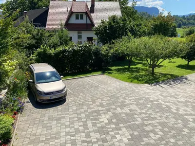 a car parked in a driveway in front of a house at Apartment Studio Van Bakel Gerard in Bled