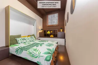 a bedroom with a bed with a green and white comforter at Apartma Relax Gaja - In the most beautiful city in the world in Ljubljana