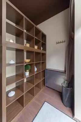 a large wooden book shelf in a room at Apartma Relax Gaja - In the most beautiful city in the world in Ljubljana