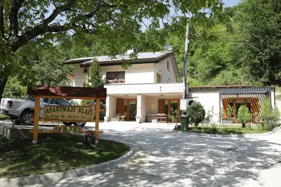 a white house with a sign in front of it at Apartments Slap in Slappe dʼIdria