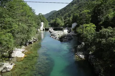 a view of a river with a bridge and trees at Apartments Slap in Slappe dʼIdria