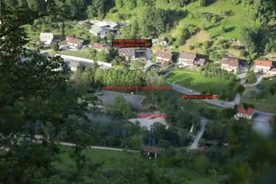 a view of a village with houses and a river at Apartments Slap in Slappe dʼIdria