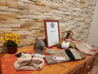 a table with knitted bags and a sign on it at River View Apartments Irena in Bohinj