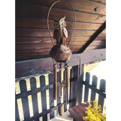 a bird ornament hanging from the eaves of a porch at River View Apartments Irena in Bohinj