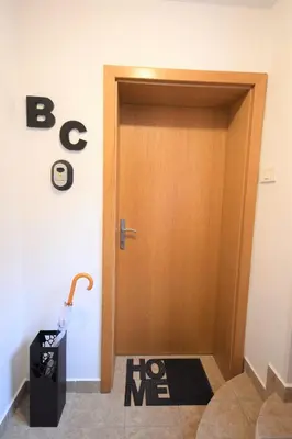 a wooden door with a sign on the floor at Apartment Bc in Bovec