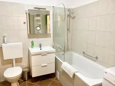 a bathroom with a toilet and a tub and a sink at Apartment Bc in Bovec