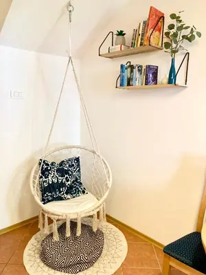 a swing chair in a living room with a pillow at Apartment Bc in Bovec