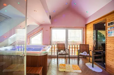 a room with a tub and two chairs in it at Luxury Apartment Ana with Hot tub in Višnja Gora