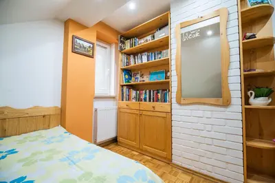 a bedroom with a bed and a book shelf at Luxury Apartment Ana with Hot tub in Višnja Gora