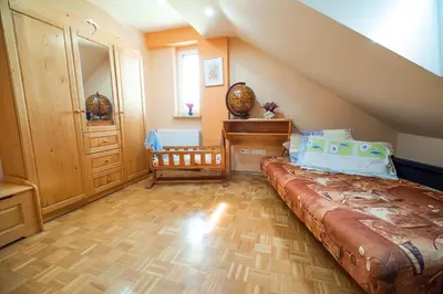 a bedroom with a large bed in a attic at Luxury Apartment Ana with Hot tub in Višnja Gora