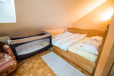 a small bedroom with a bed with an open trunk at Luxury Apartment Ana with Hot tub in Višnja Gora