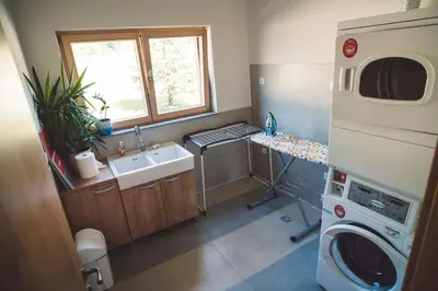 a small bathroom with a sink and a washing machine at Camp Podgrad Vransko in Vransko