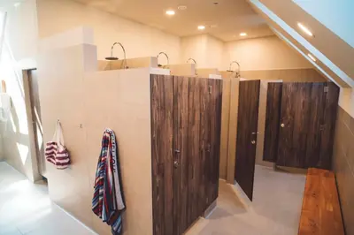a bathroom with four wooden cabinets on the wall at Camp Podgrad Vransko in Vransko