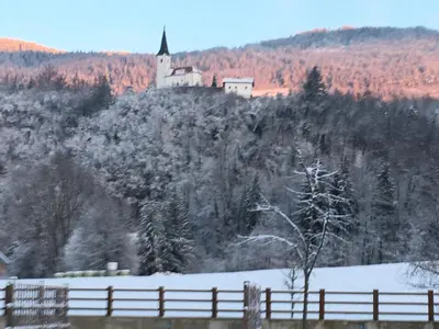 a castle on top of a hill with a fence at Camp Podgrad Vransko in Vransko