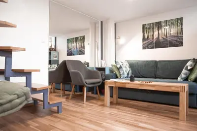 a living room with a couch and a table at Stylish Apartment with Castle View & Free Parking in Ljubljana