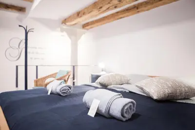 a large bed with towels on top of it at Stylish Apartment with Castle View & Free Parking in Ljubljana
