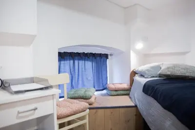 a small bedroom with a bed and a window at Stylish Apartment with Castle View & Free Parking in Ljubljana