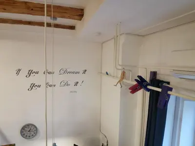 a room with a clock on the wall at Stylish Apartment with Castle View & Free Parking in Ljubljana