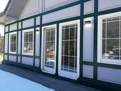 a black and white building with white windows at Apartments ViTa in Kranjska Gora