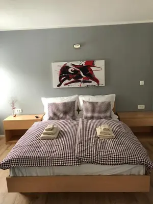 a bedroom with a bed with two towels on it at Apartments ViTa in Kranjska Gora
