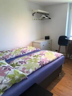a bedroom with a bed and a desk and a chair at Castle View Studio in Ljubljana