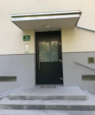 a black door on a building with stairs at Castle View Studio in Ljubljana