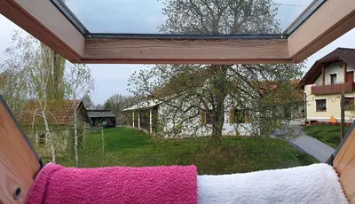 a view from a room with pink and white towels at Beautiful house surrounded by pure nature in Rogašovci