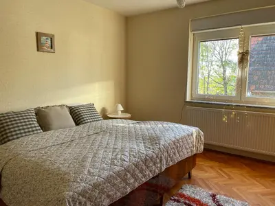 a bedroom with a bed and a large window at Beautiful house surrounded by pure nature in Rogašovci