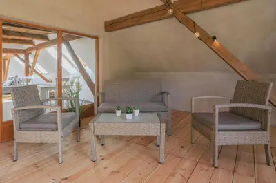 a room with two chairs and a table with at Apartment Krnicar in Zgornje Gorje