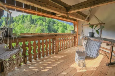 a porch with hammocks and a view of the forest at Apartment Krnicar in Zgornje Gorje