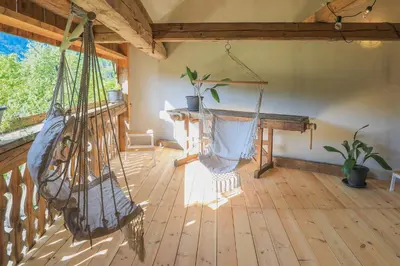 a room with a hammock on a wooden floor at Apartment Krnicar in Zgornje Gorje