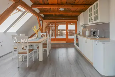 a kitchen and dining room with a table and chairs at Apartment Krnicar in Zgornje Gorje