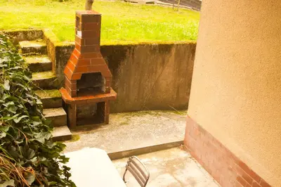a brick oven in a yard next to a building at Na Kopitarjevi in Laško