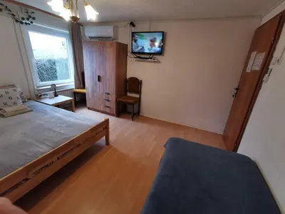 a bedroom with a bed and a tv on a wall at Na Kopitarjevi in Laško
