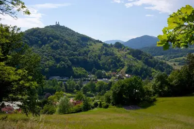 a valley in the mountains with a town on a hill at Na Kopitarjevi in Laško
