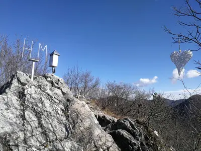 a sign on top of a rocky mountain at Na Kopitarjevi in Laško