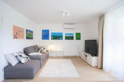 a living room with a couch and a tv at Apartment Galerija Bled in Bled