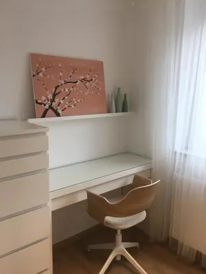 a desk with a chair and a painting on the wall at Apartment Galerija Bled in Bled