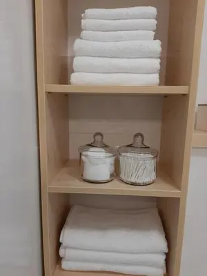a towel rack with towels and towels in a bathroom at Apartment Galerija Bled in Bled