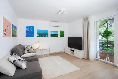 a living room with a couch and a tv at Apartment Galerija Bled in Bled