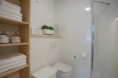 a bathroom with a shower and a toilet and towels at Apartment Galerija Bled in Bled