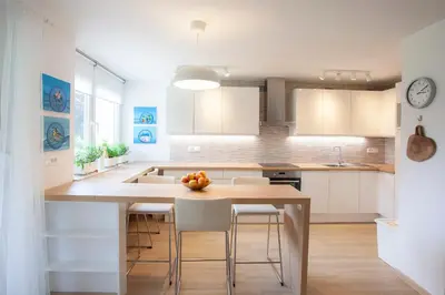 a kitchen with a table with chairs and a counter top at Apartment Galerija Bled in Bled