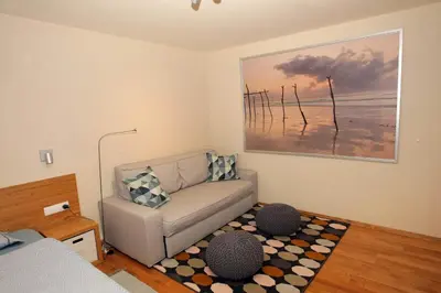 a living room with a couch and a painting on the wall at Apartma LODI BOHINJ Za dve,štiri, šest, ali osem oseb in Bohinj