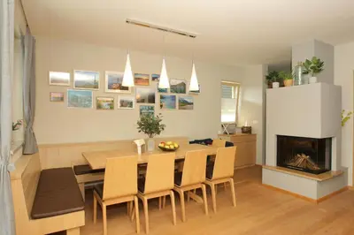 a dining room with a table and a fireplace at Apartma LODI BOHINJ Za dve,štiri, šest, ali osem oseb in Bohinj
